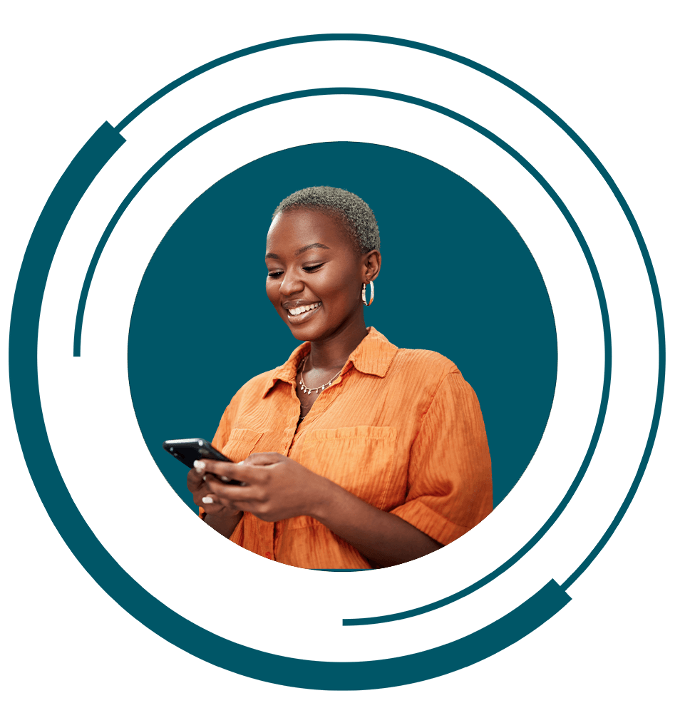 women smiling brightly and using their phone