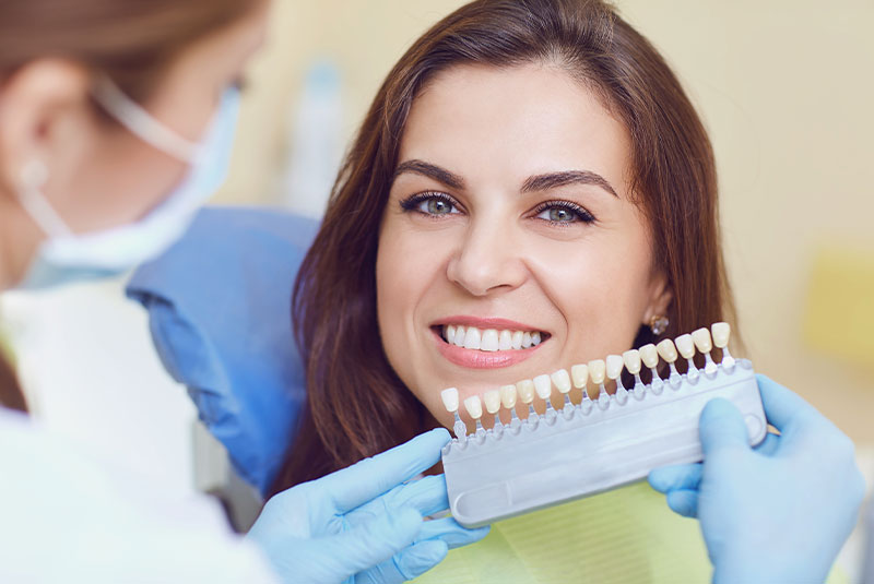 Closeup of a young woman with beautiful smile at the dentist