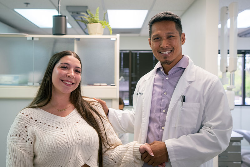 patient and doctor shaking hands and smiling